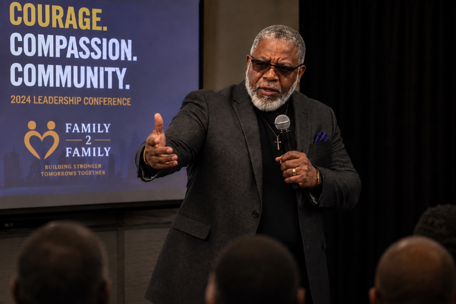 The Elder King Latham addressing the Family 2 Family leadership conference, hand extended to the room